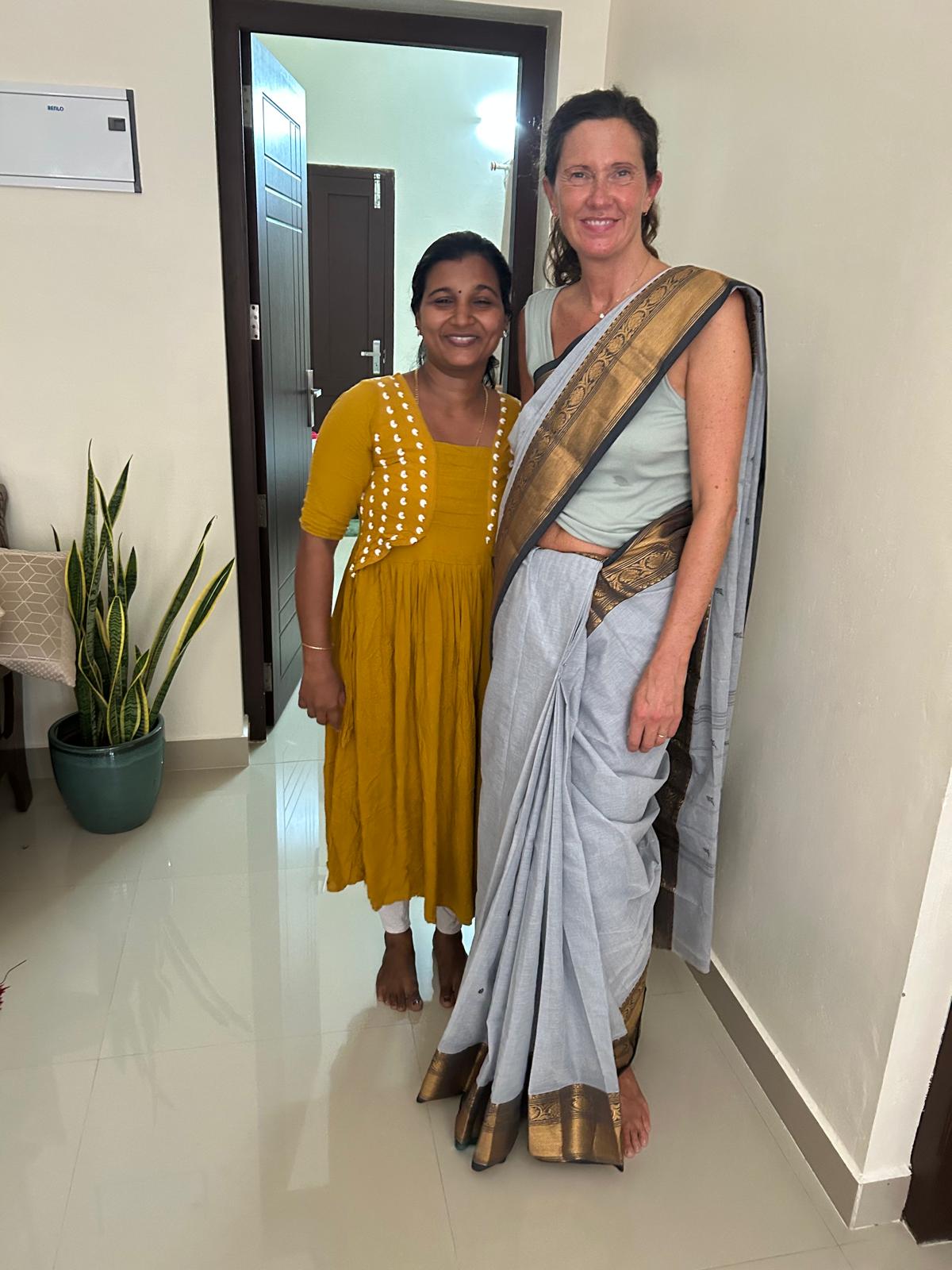 Lottie in a blue saree beside Jesna