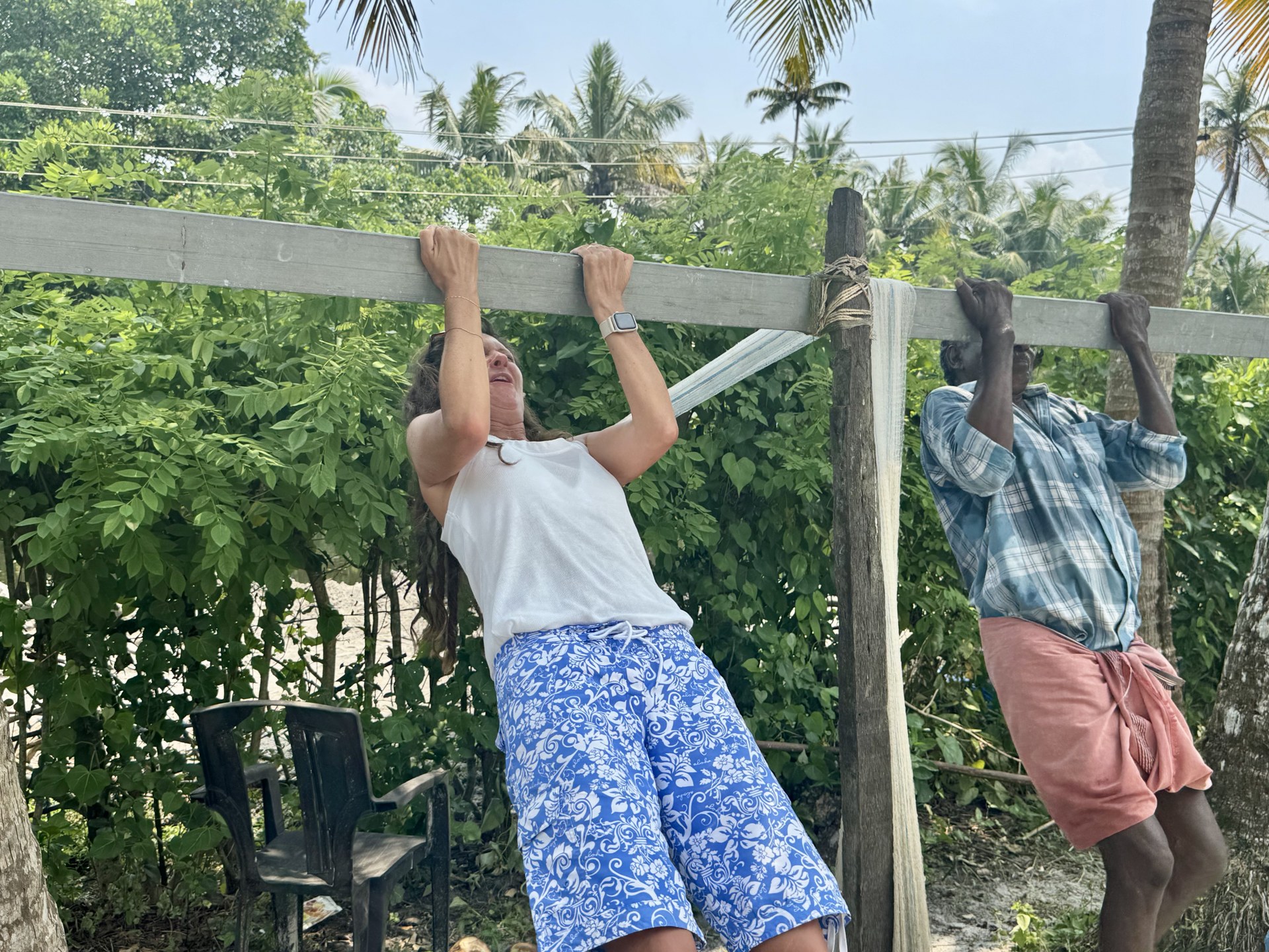 Lottie and our fish-farmer host hanging from a wooden beam