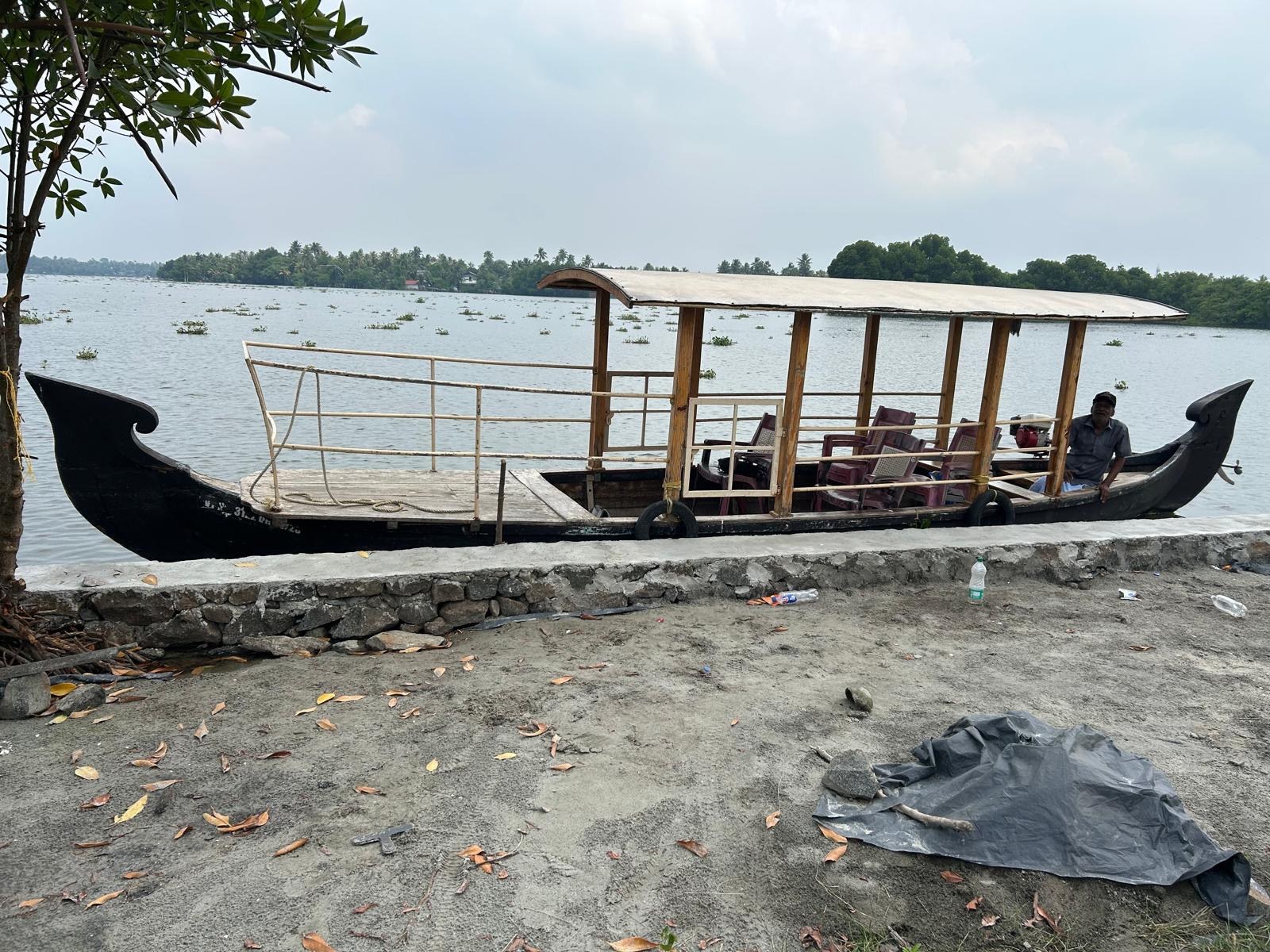 The covered wooden boat used for our backwater trip with Joseph