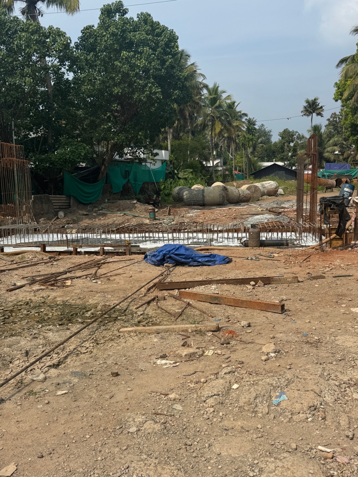 Steel reinforcement cages and freshly poured concrete at the new bridge construction site