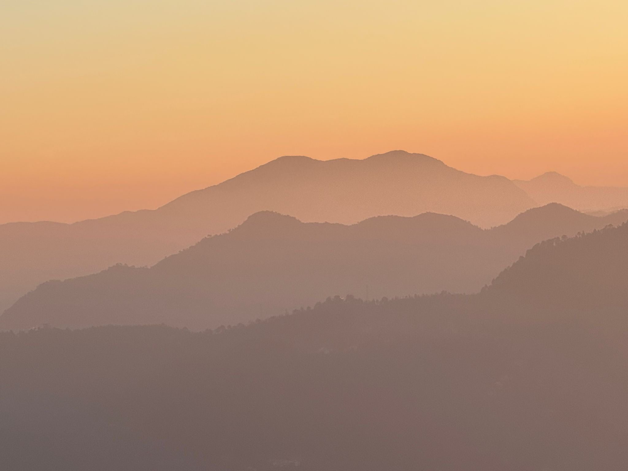 Layered hills at sunset